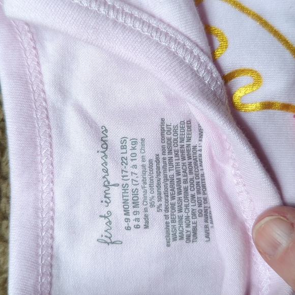 Cute pink holiday onesie with red bow and sleepy reindeer on front - Picture 3 of 5